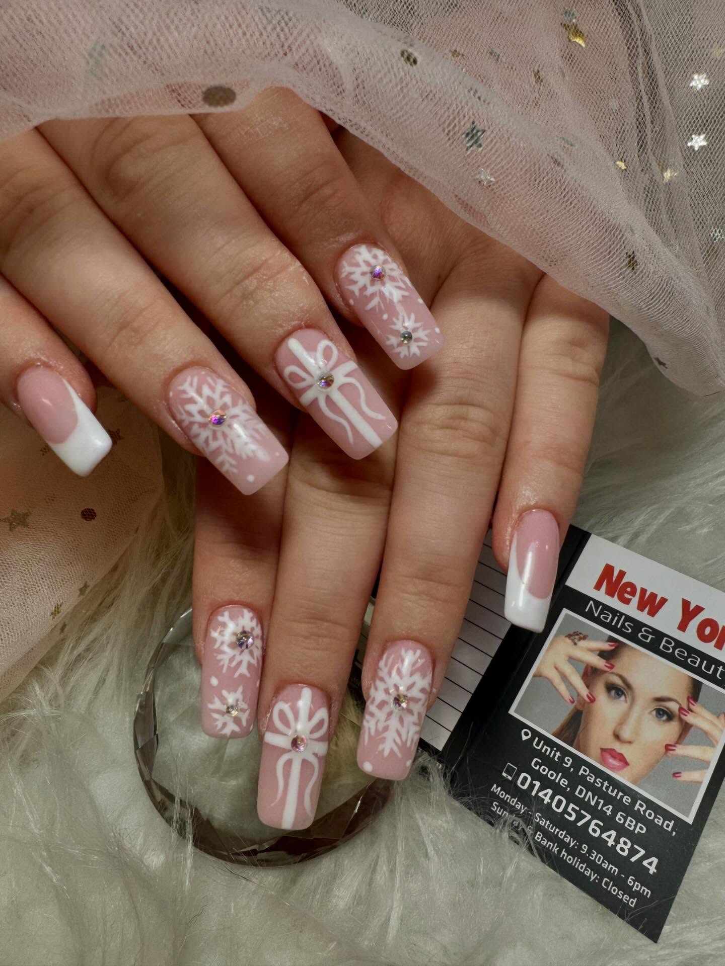 Pink nails with white bows and snowflakes