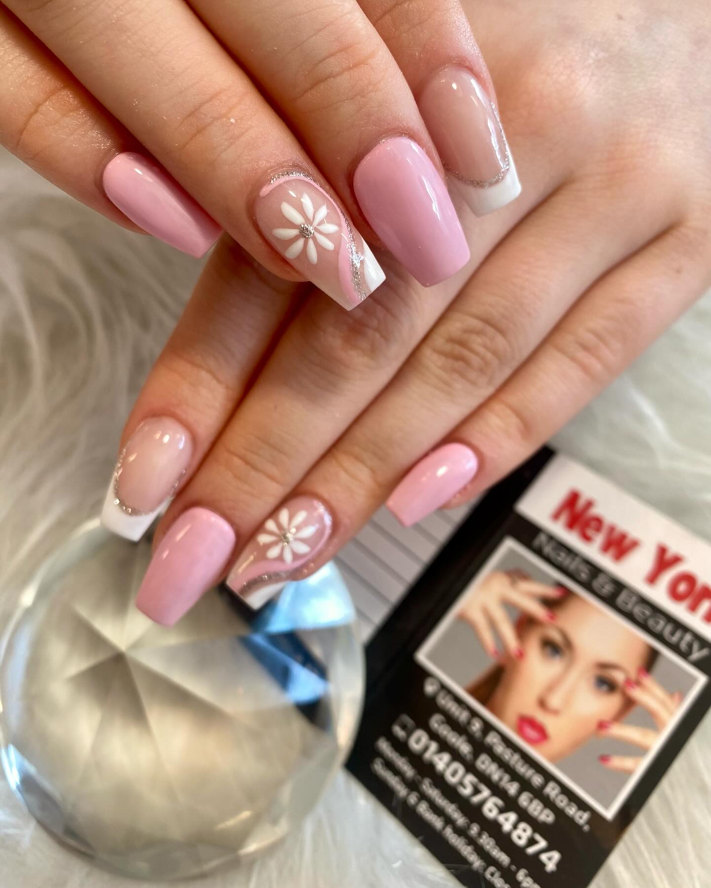 Pink nails with white flower art